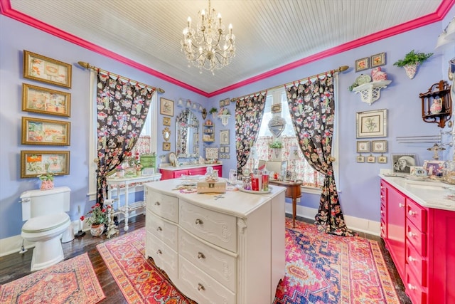 interior space featuring a chandelier, hardwood / wood-style flooring, vanity, toilet, and crown molding