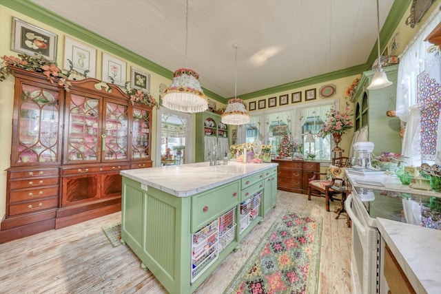 kitchen with pendant lighting, crown molding, white range with electric cooktop, a kitchen island, and light wood-type flooring