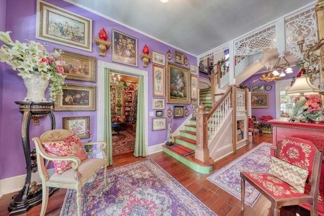 stairway featuring ornamental molding and wood-type flooring