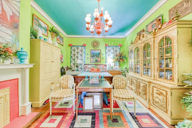 sitting room with ornamental molding, an inviting chandelier, and light hardwood / wood-style flooring