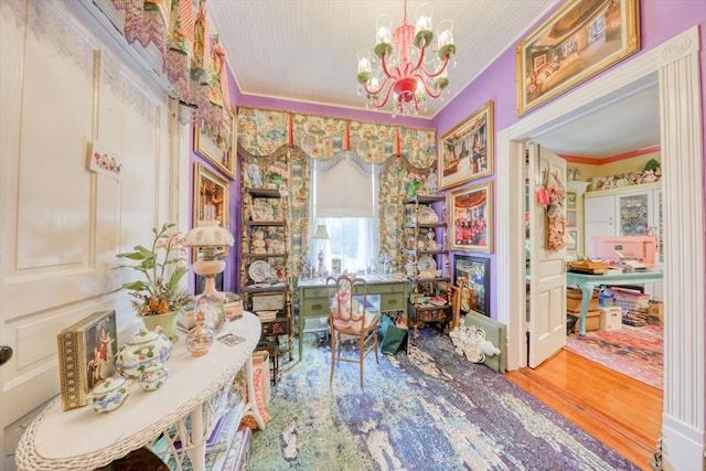 interior space with crown molding, a notable chandelier, and hardwood / wood-style flooring