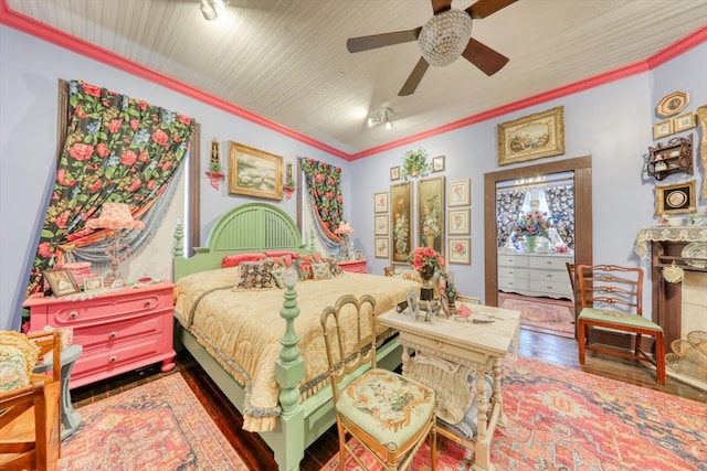 bedroom with ornamental molding, wood-type flooring, and ceiling fan