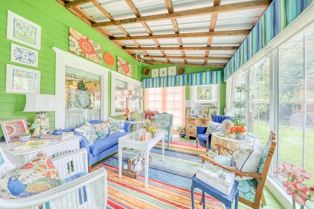 sunroom / solarium featuring plenty of natural light and vaulted ceiling