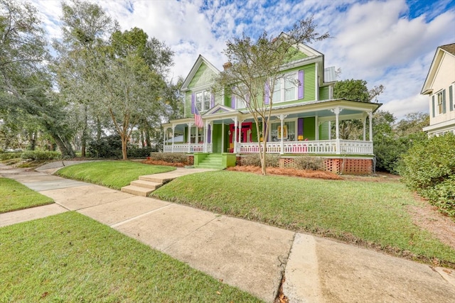 victorian home featuring a porch and a front yard