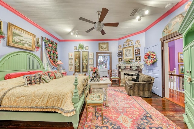 bedroom featuring ceiling fan, ornamental molding, and dark hardwood / wood-style flooring