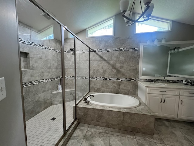 bathroom featuring vanity, a wealth of natural light, vaulted ceiling, and plus walk in shower