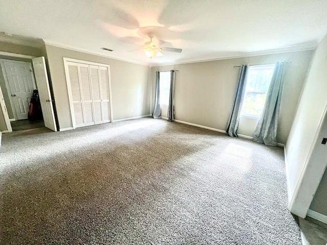 unfurnished bedroom featuring ornamental molding, a closet, and ceiling fan