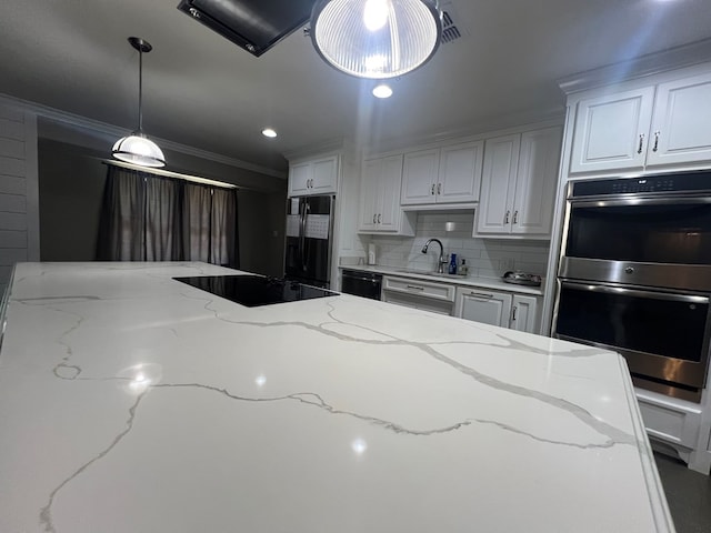 kitchen featuring sink, white cabinetry, hanging light fixtures, light stone countertops, and black appliances