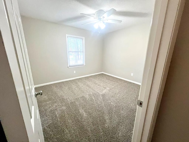 spare room with carpet flooring and ceiling fan