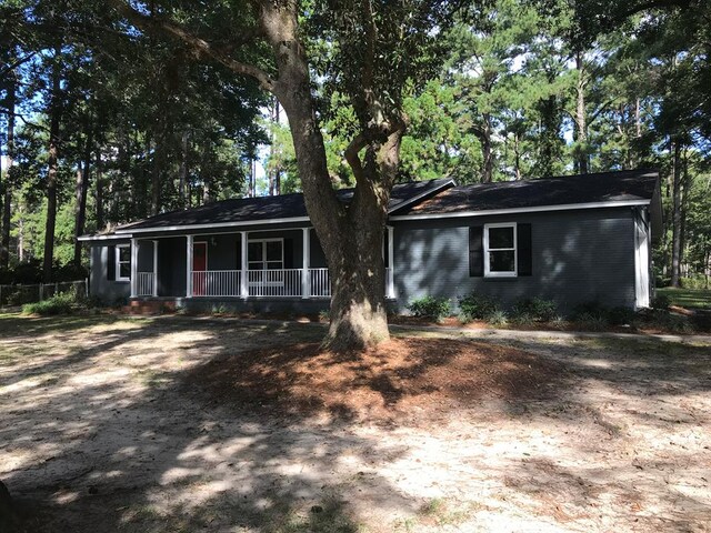 ranch-style house with covered porch