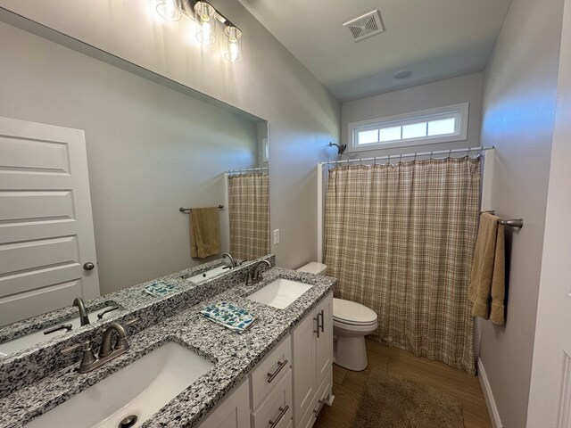 kitchen with stainless steel fridge, ornamental molding, custom exhaust hood, light wood-style floors, and a sink