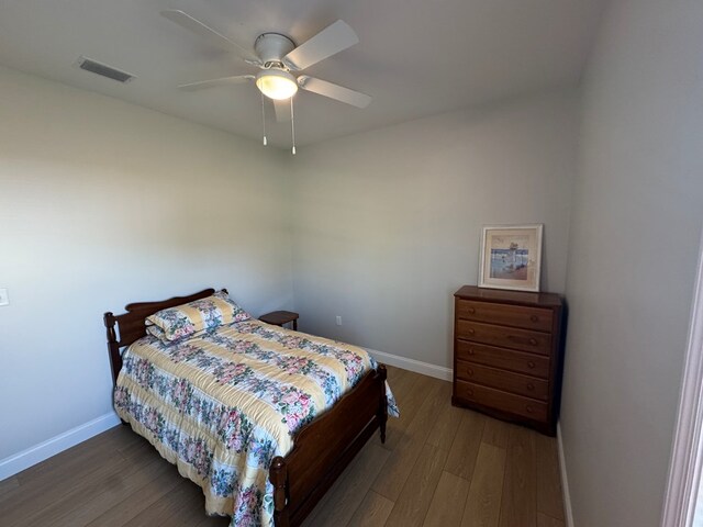 bedroom with baseboards, a closet, and wood finished floors