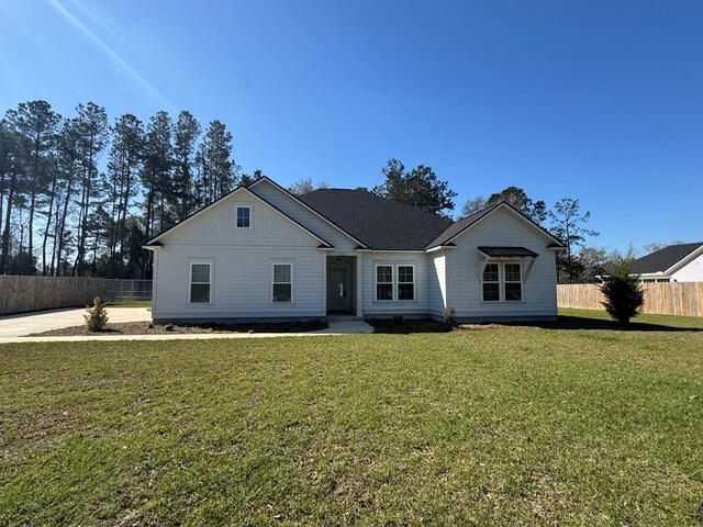 view of front of house with fence and a front yard