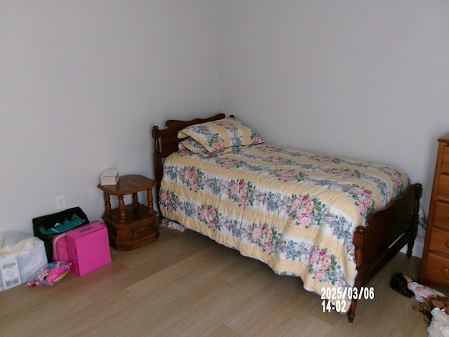 bedroom with wood finished floors