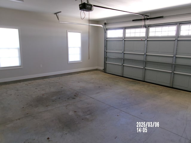 garage featuring a garage door opener and baseboards