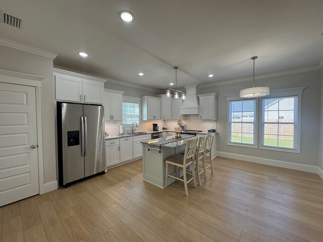 bedroom featuring ornamental molding and wood finished floors