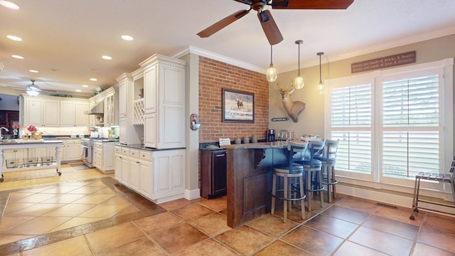 1017 Rowland Rd, Boston, GA 31626 - kitchen with ceiling fan, high end stainless steel range oven, recessed lighting, a kitchen bar, and light tile patterned flooring