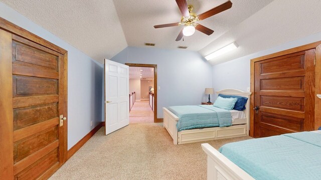 1017 Rowland Rd, Boston, GA 31626 - bedroom with lofted ceiling, light colored carpet, a textured ceiling, baseboards, and a ceiling fan