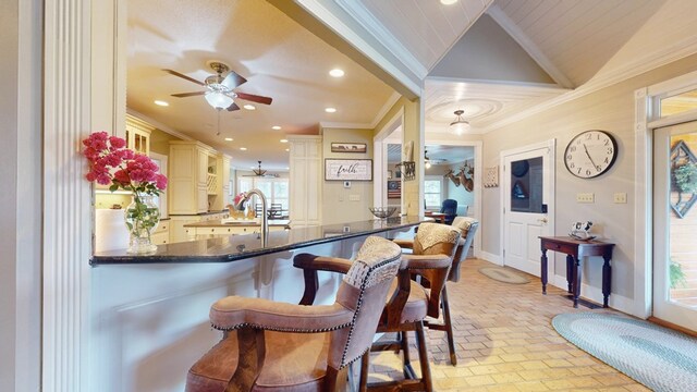 1017 Rowland Rd, Boston, GA 31626 - bar featuring ornamental molding, a ceiling fan, brick floors, baseboards, and plenty of natural light