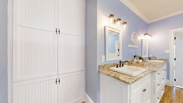 1017 Rowland Rd, Boston, GA 31626 - bathroom featuring double vanity, ornamental molding, baseboards, and wood finished floors