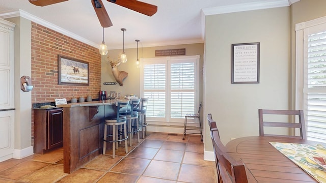 1017 Rowland Rd, Boston, GA 31626 - kitchen featuring a ceiling fan, a breakfast bar, healthy amount of natural light, crown molding, and light tile patterned flooring