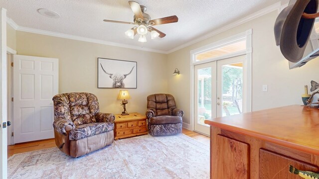 1017 Rowland Rd, Boston, GA 31626 - sitting room featuring french doors, light wood-type flooring, crown molding, a ceiling fan, and a textured ceiling