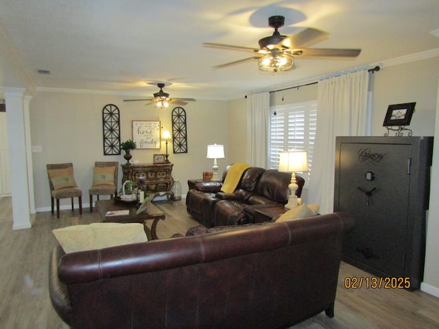 living room with hardwood / wood-style flooring, ceiling fan, ornamental molding, and ornate columns