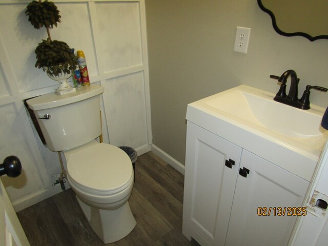 bathroom with vanity, wood-type flooring, and toilet