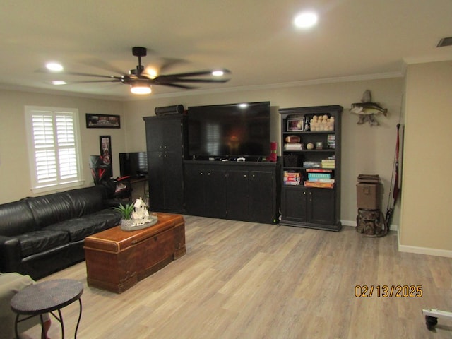 living room with crown molding, ceiling fan, and light hardwood / wood-style flooring