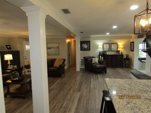 living room with decorative columns, ornamental molding, and dark hardwood / wood-style flooring