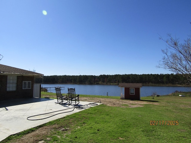 exterior space with a water view, a storage unit, and a patio