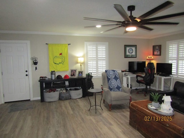 living room featuring hardwood / wood-style flooring, a wealth of natural light, ornamental molding, and ceiling fan