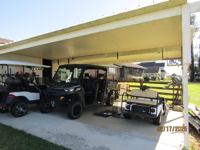 garage featuring a yard and a carport