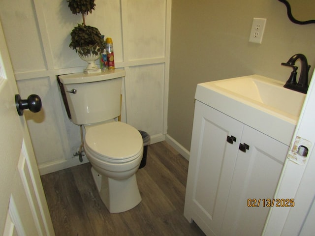 bathroom with vanity, wood-type flooring, and toilet