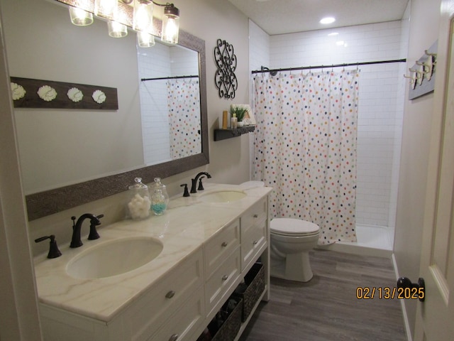 bathroom featuring vanity, toilet, a shower with shower curtain, and wood-type flooring