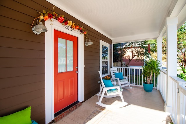 view of exterior entry with a porch