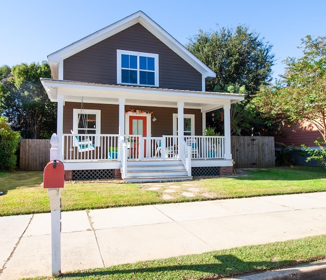 view of front of property featuring a front yard and covered porch