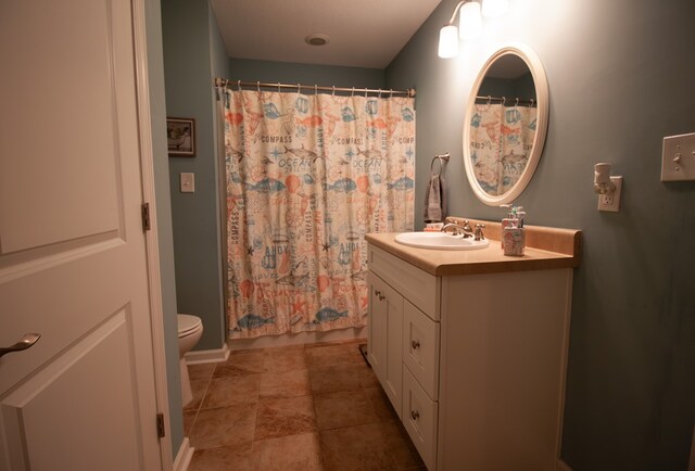 full bathroom with vanity, shower / bath combo, and toilet