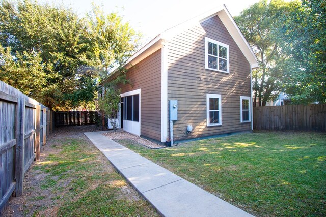 view of side of home featuring a yard