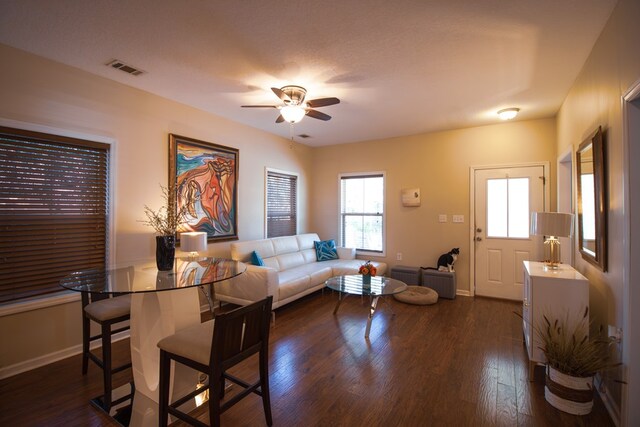 living room featuring dark hardwood / wood-style floors and ceiling fan