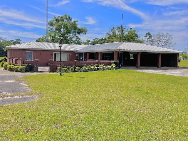 ranch-style home featuring a carport and a front lawn