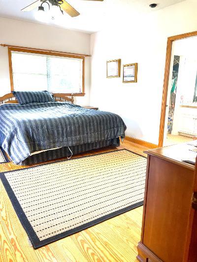 bedroom featuring ceiling fan and light wood-type flooring