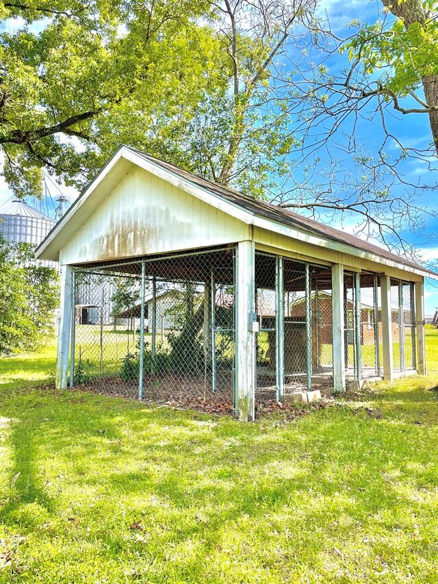 view of home's community with a yard and an outdoor structure