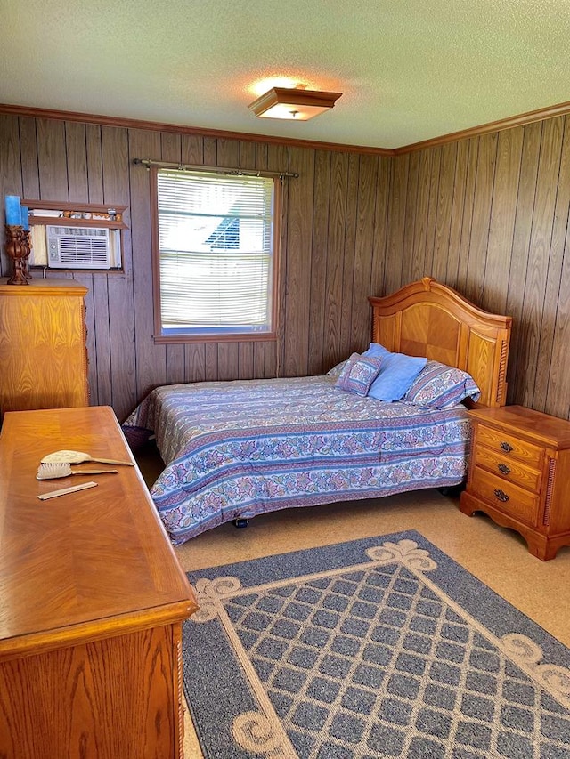 bedroom featuring cooling unit, carpet floors, a textured ceiling, and wood walls