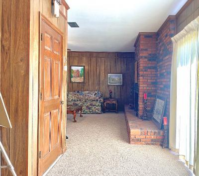 corridor with carpet floors and wood walls