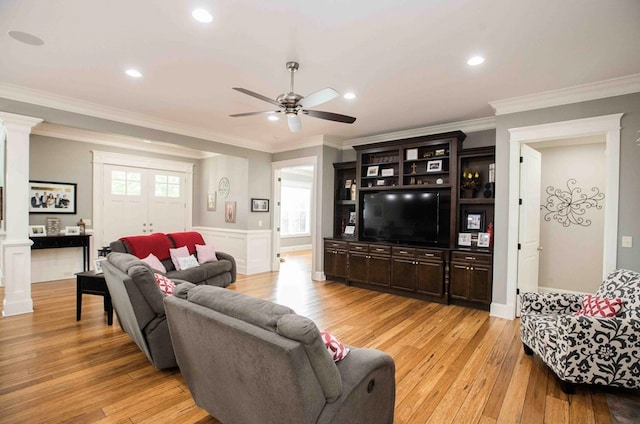 living area with ornamental molding, light wood-type flooring, decorative columns, and recessed lighting