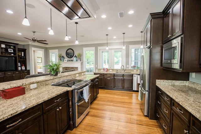 kitchen featuring appliances with stainless steel finishes, a sink, and crown molding