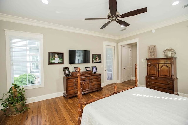 bedroom with visible vents, ornamental molding, ceiling fan, wood finished floors, and baseboards