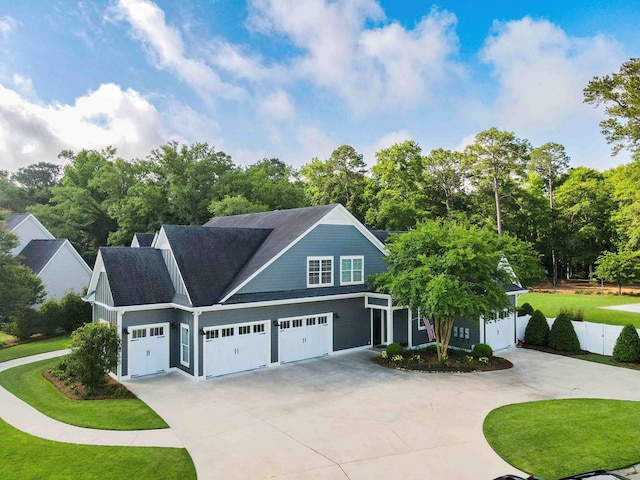 view of front of home featuring a garage, a front yard, and driveway