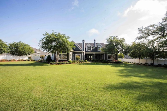 view of front of house with fence and a front yard